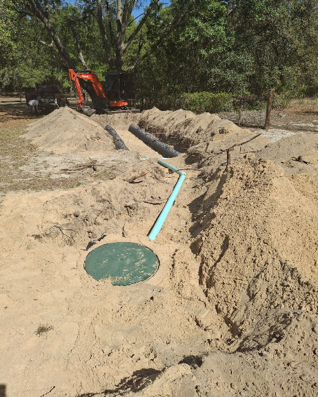 Full septic system installation with excavator, tank and lines set